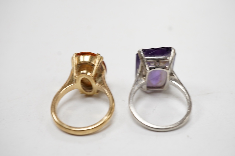Two dress rings: one a rectangular cut amethyst set in platinum, size M and a 9ct gold and oval cut citrine, size L.